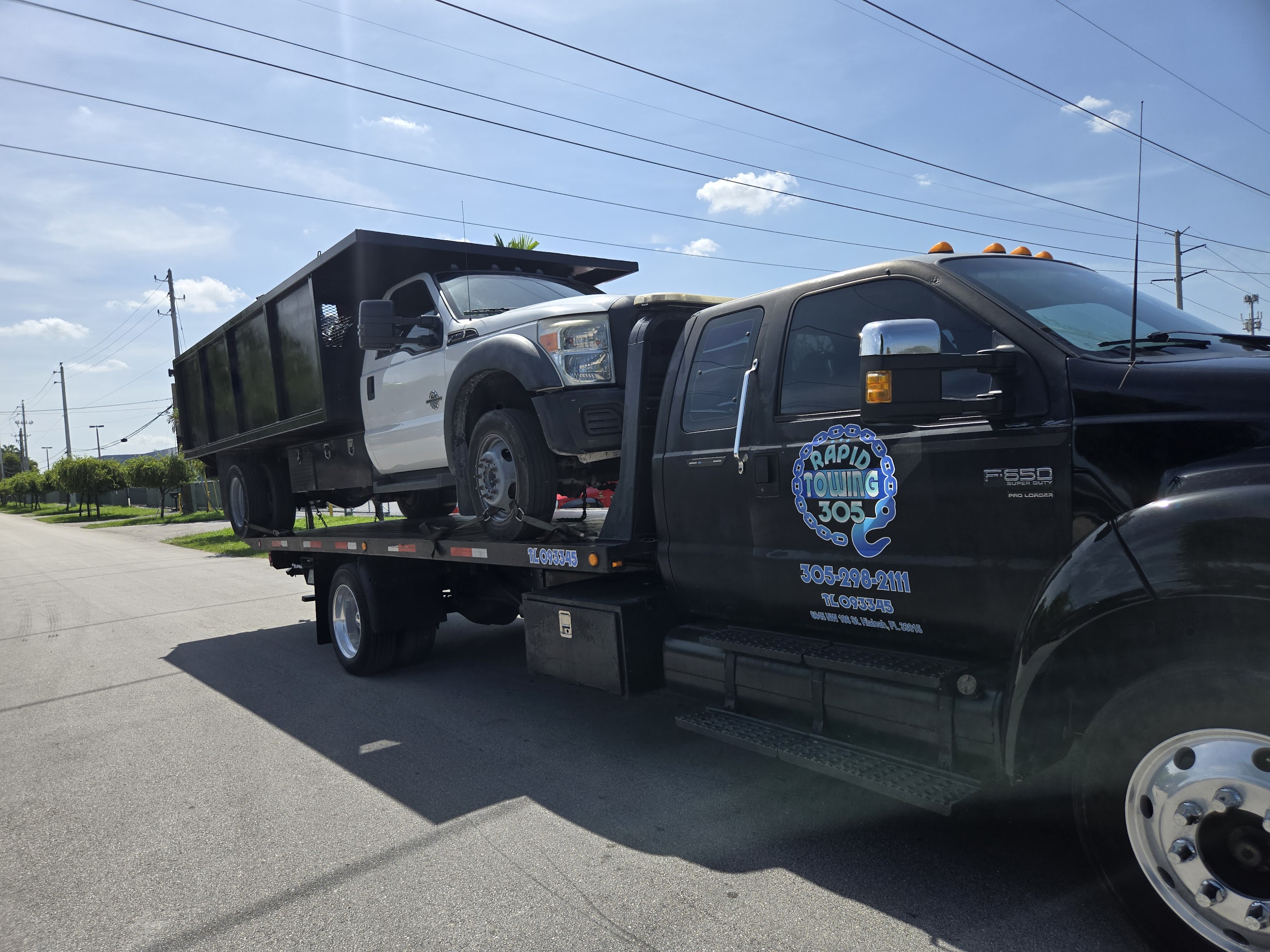 Professional flatbed towing of commercial dump truck