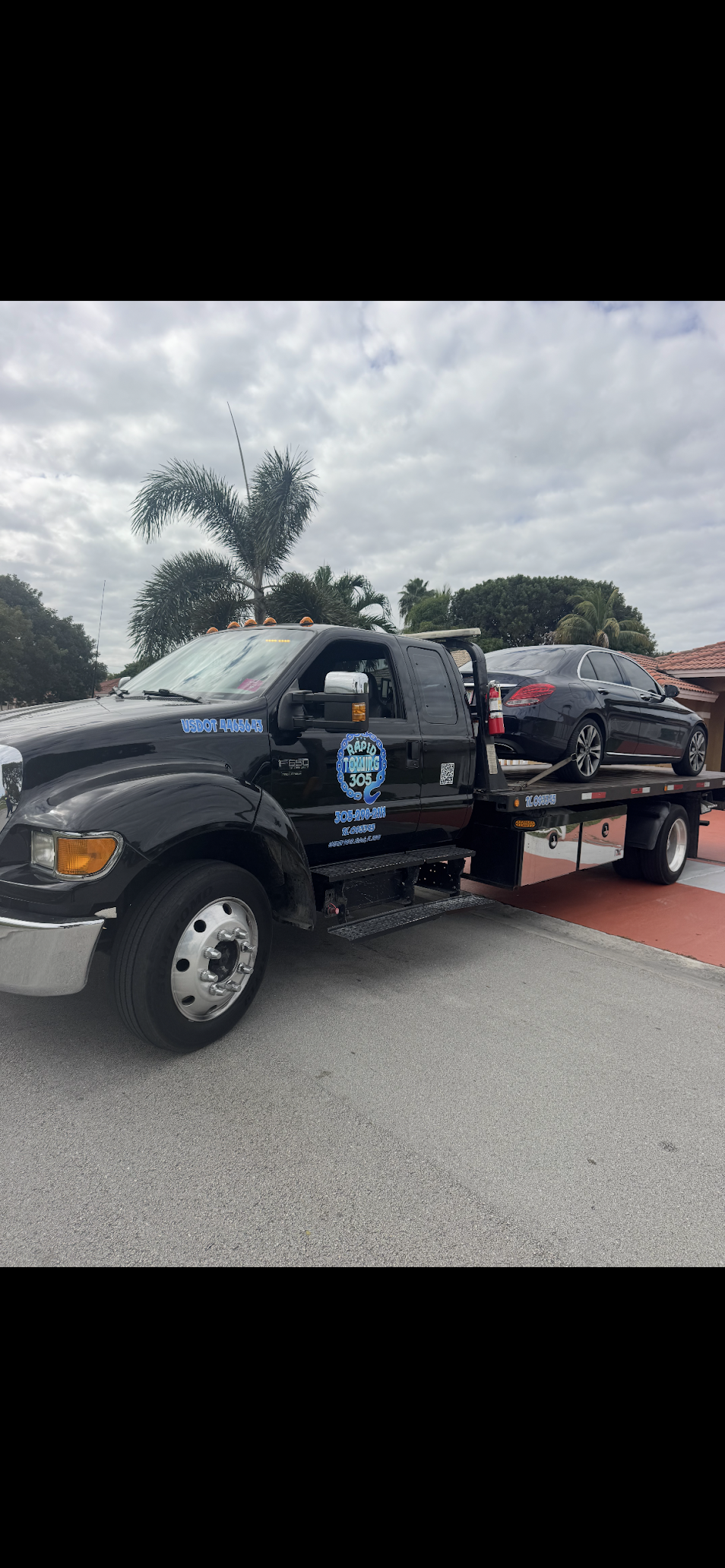 Rapid Towing 305 flatbed towing sedan with care